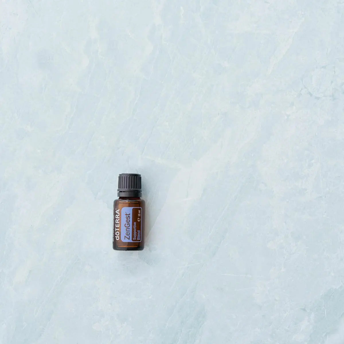 ZenGest doTERRA 15ml — frasco sobre fundo mármore azul, óleo essencial digestivo puro CPTG, aromaterapia