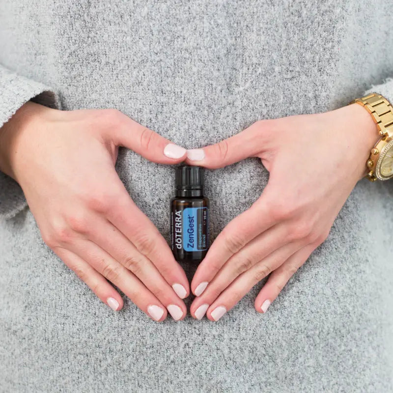 ZenGest doTERRA 15ml — mãos sobre abdómen, aplicação tópica, óleo essencial digestivo puro CPTG