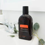 Elixir Oral On Guard doTERRA 473ml — frasco sobre bancada de banho com folhas de eucalipto, aromaterapia, óleo essencial puro CPTG