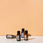 Mistura Purify doTERRA 15ml — quatro frascos escalonados em superfície branca, fundo laranja, óleo essencial puro CPTG