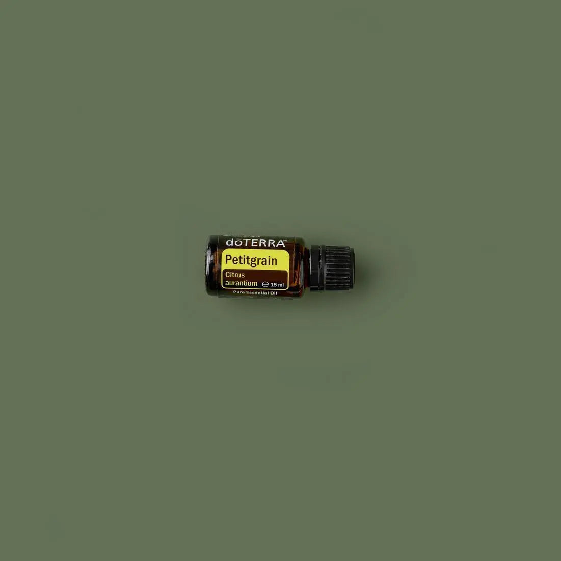 Óleo Essencial de Petitgrain doTERRA 15ml frasco inclinado superfície verde oliva — aromaterapia CPTG