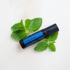 Deep Blue Touch doTERRA Roll-on 10ml — folhas de hortelã fresca em superfície branca cenital, alivo natural CPTG