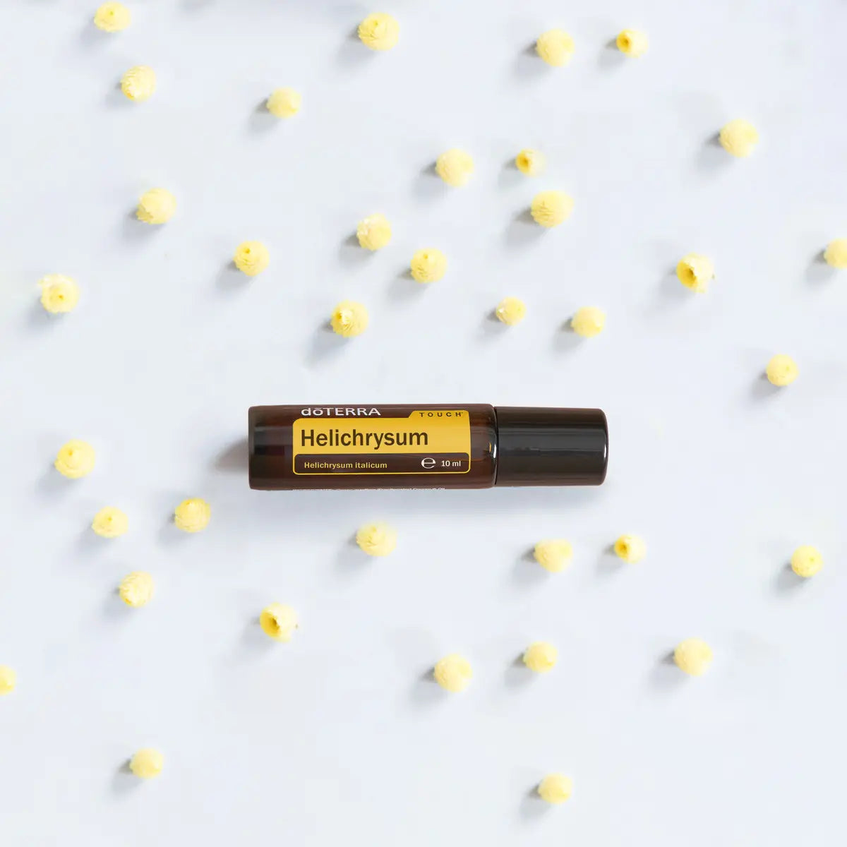 Helichrysum Touch doTERRA Roll-on 10ml — prato cerâmico com flores brancas, cuidado pele natural CPTG