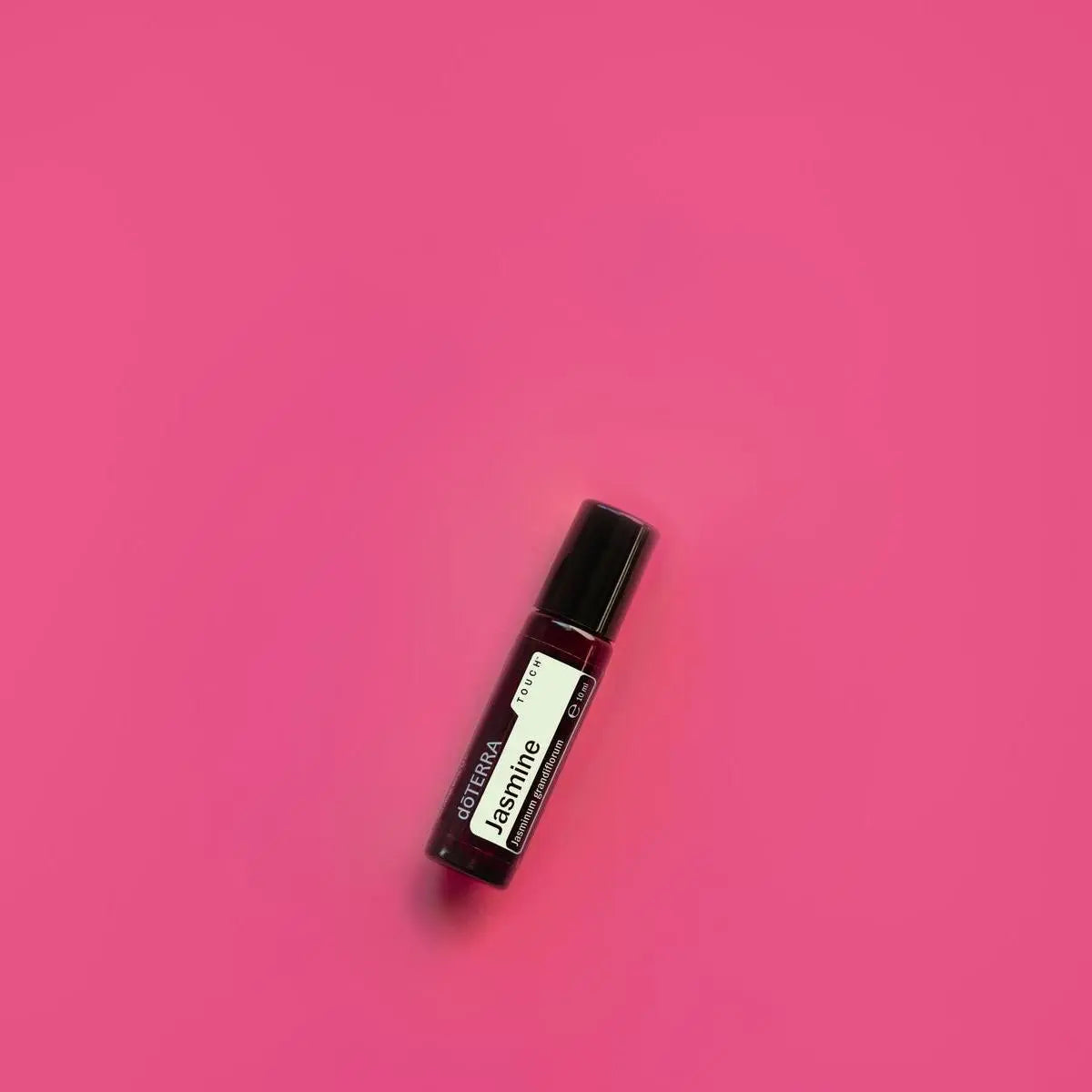 Roll-On Jasmim Touch doTERRA 10ml — fundo fúcsia vibrante vista de cima, óleo essencial de jasmim puro doTERRA