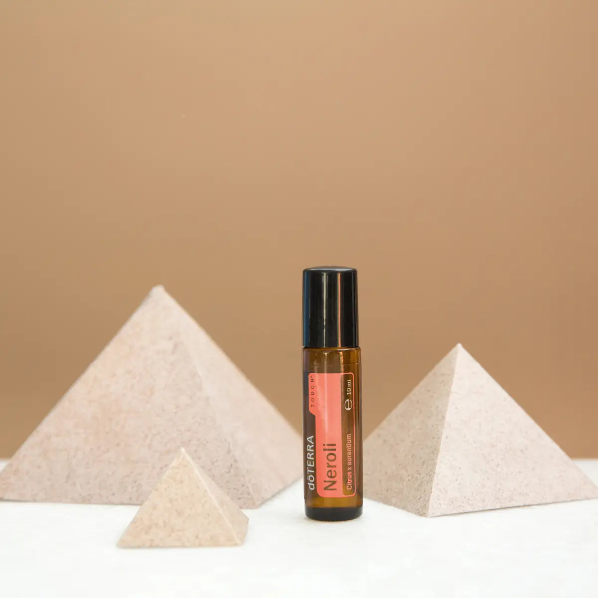 Roll-On Neroli Touch doTERRA 10ml — pirâmides de pedra fundo bege minimalista, aromaterapia neroli doTERRA