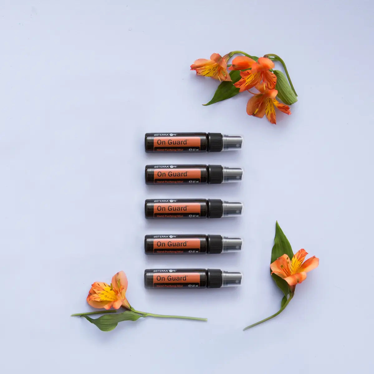 On Guard Spray Purificante doTERRA 27ml — pack de 5 em coluna com flores laranja, óleo essencial protetor CPTG
