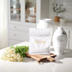 Proteína Vegetal Baunilha doTERRA 512g — saco com jarros brancos e camomila, proteína vegetal natural certificada