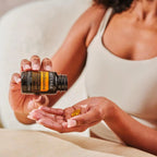 Cápsulas moles Zendocrine doTERRA mãos com frasco inclinado e softgel na palma — suplemento detox natural CPTG